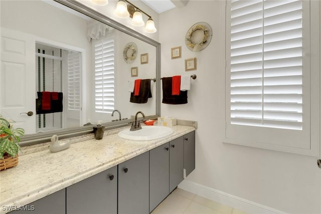 bathroom with tile patterned flooring, baseboards, and vanity