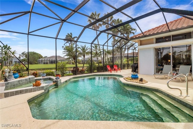 view of pool featuring a lanai, a patio area, and a pool with connected hot tub