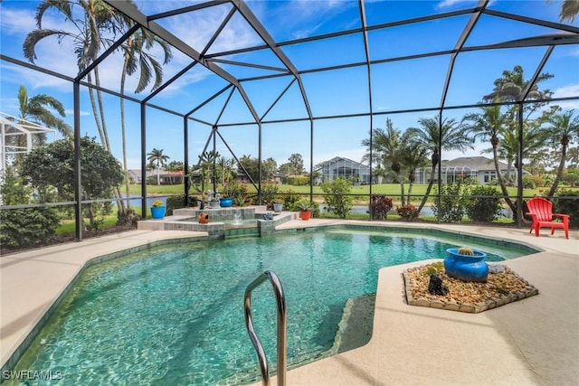 view of swimming pool with a patio area, glass enclosure, and a pool with connected hot tub