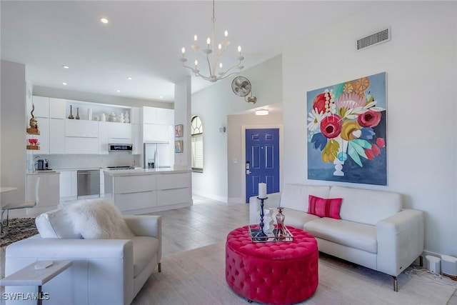 living room with a notable chandelier, baseboards, visible vents, and recessed lighting