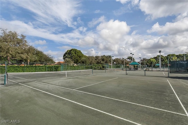 view of sport court featuring fence