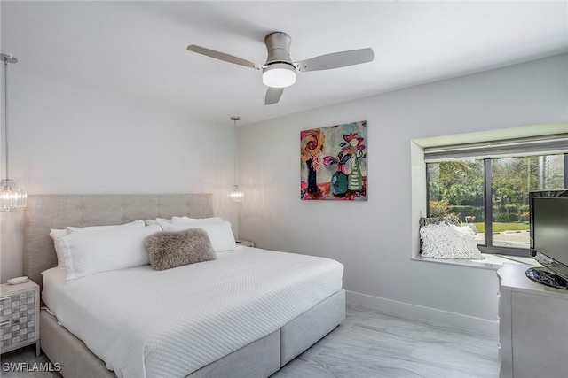 bedroom featuring ceiling fan and baseboards