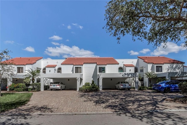 mediterranean / spanish-style home with uncovered parking, a residential view, and a tile roof