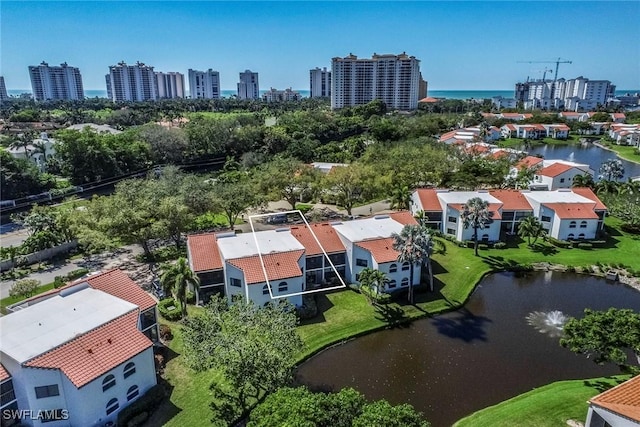 birds eye view of property featuring a water view and a city view