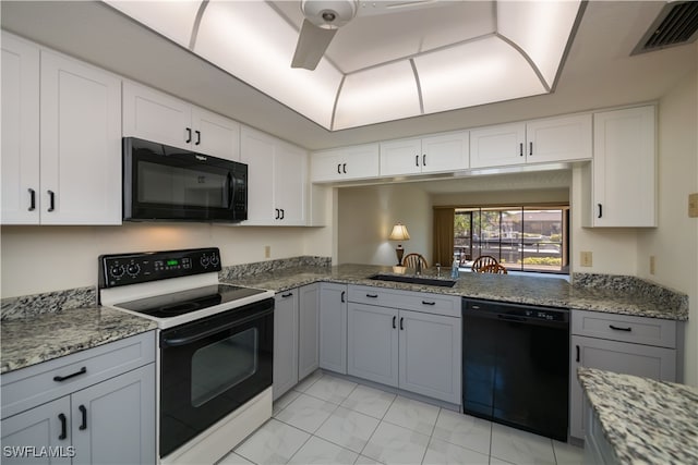 kitchen featuring gray cabinets, visible vents, a ceiling fan, light stone countertops, and black appliances