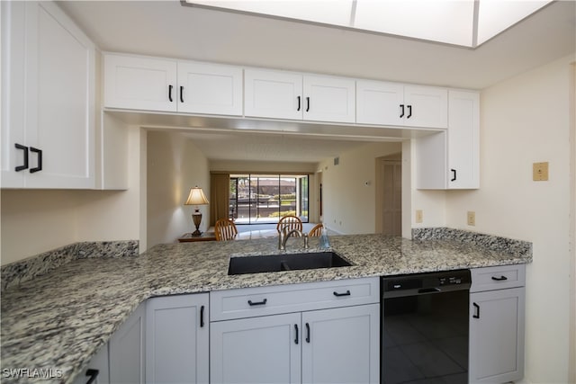 kitchen featuring white cabinetry, black dishwasher, light stone counters, and a sink