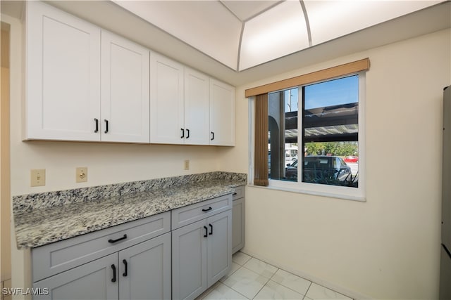 kitchen with light stone counters and white cabinets