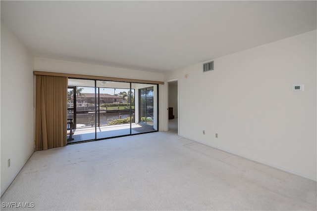 unfurnished room with light carpet and visible vents