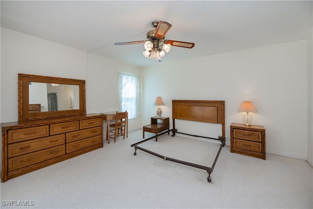 bedroom with light carpet and a ceiling fan