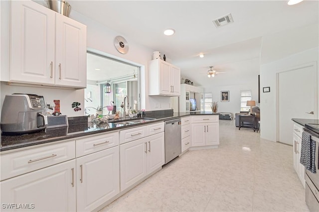 kitchen with stainless steel appliances, visible vents, a sink, and white cabinetry