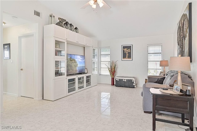 living room with ceiling fan, plenty of natural light, visible vents, and baseboards