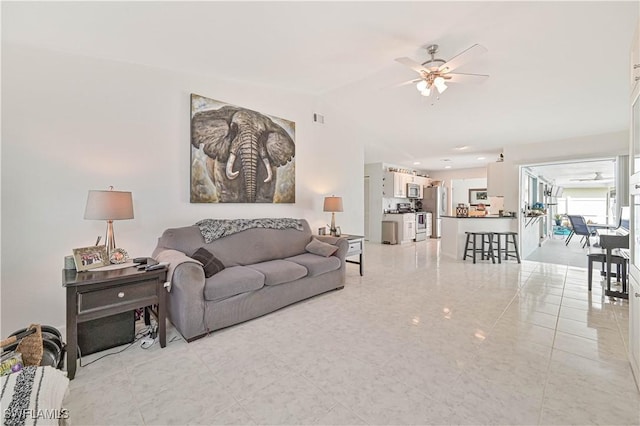 living area featuring lofted ceiling and ceiling fan