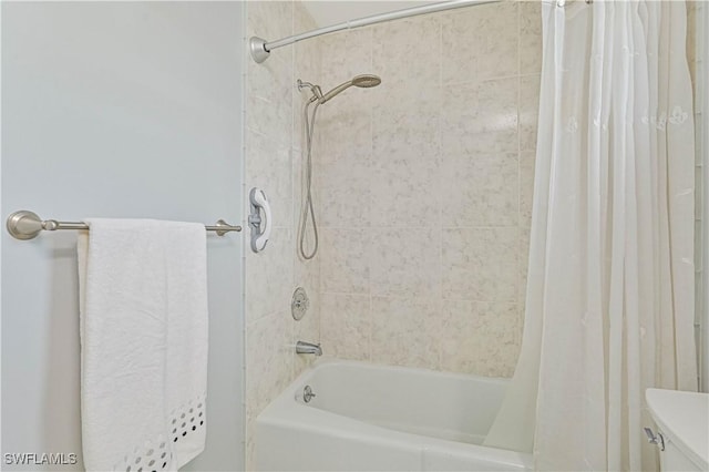 bathroom featuring shower / bath combo and toilet