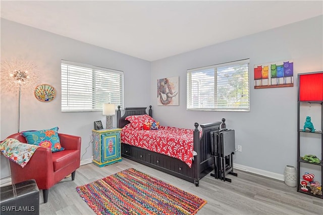 bedroom featuring baseboards and wood finished floors