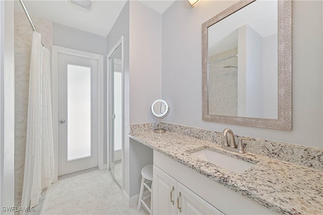 bathroom with tile patterned flooring, vanity, and a shower with shower curtain