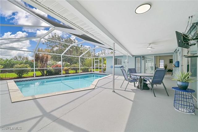 pool featuring a ceiling fan, glass enclosure, and a patio