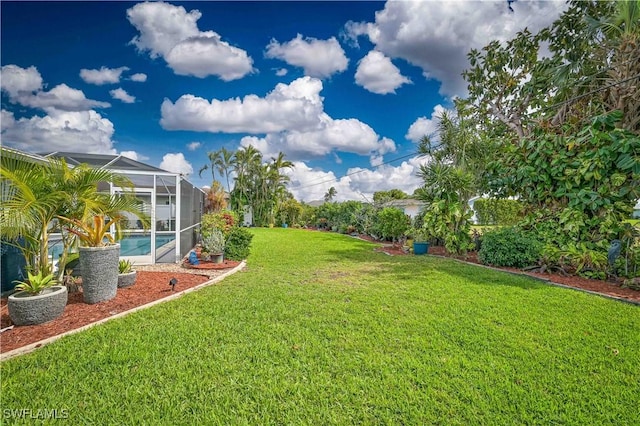 view of yard with glass enclosure and an outdoor pool