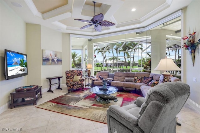 living room with baseboards, a ceiling fan, a sunroom, a high ceiling, and crown molding