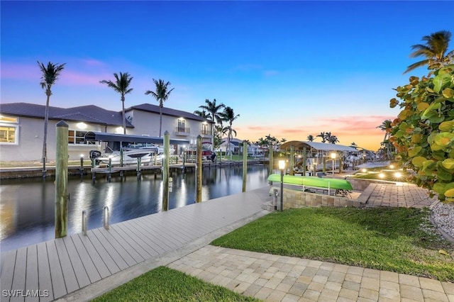 dock area featuring a yard, a water view, and boat lift