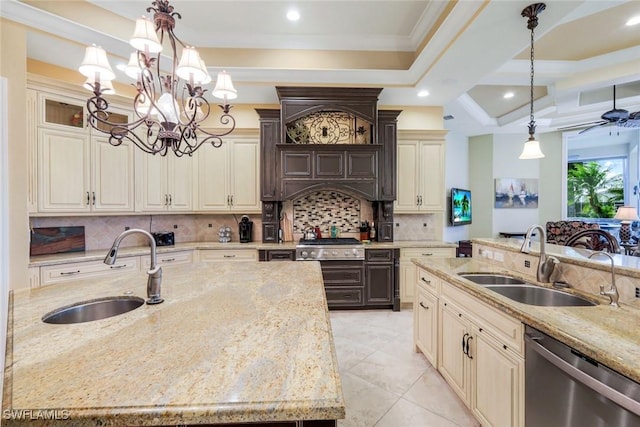 kitchen featuring dark brown cabinetry, dishwasher, hanging light fixtures, and a sink