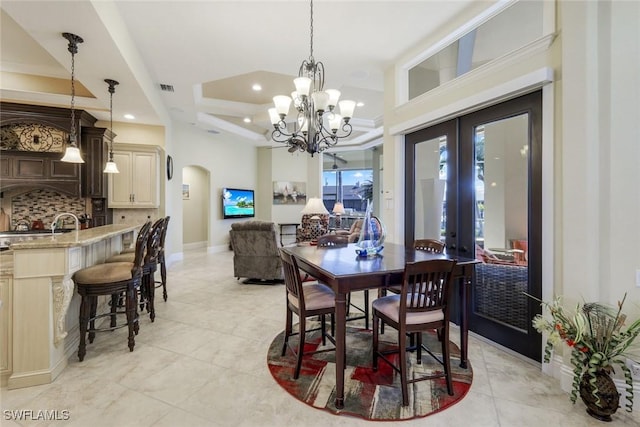 dining space featuring visible vents, arched walkways, a raised ceiling, french doors, and recessed lighting