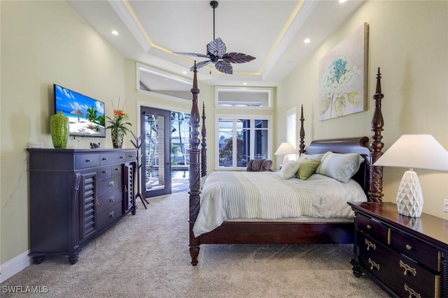 bedroom with baseboards, a raised ceiling, light colored carpet, access to outside, and recessed lighting