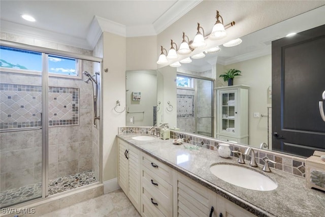 full bathroom featuring double vanity, crown molding, and a sink