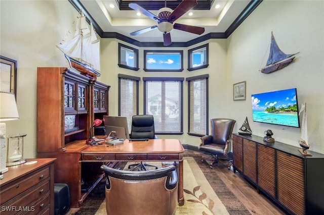 office featuring recessed lighting, wood finished floors, a ceiling fan, a towering ceiling, and crown molding