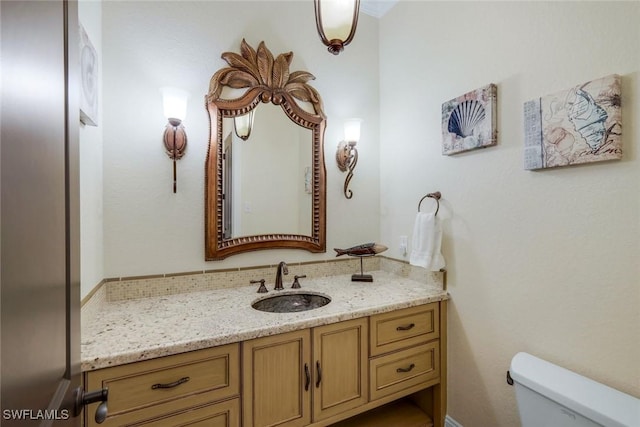 bathroom featuring vanity and toilet