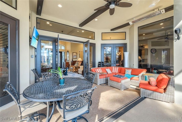 view of patio with ceiling fan, french doors, outdoor dining area, and an outdoor living space with a fire pit