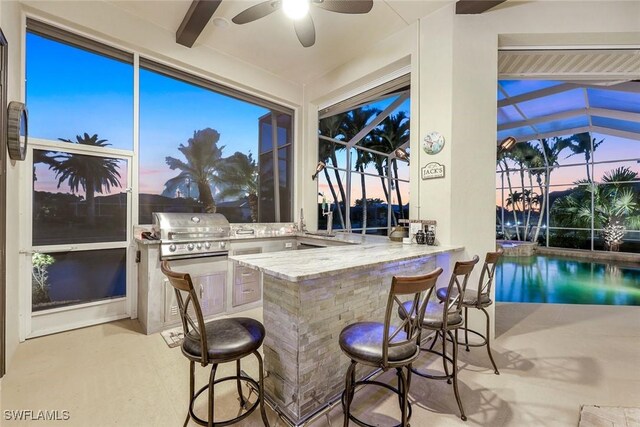 interior space featuring a peninsula, a sunroom, and a breakfast bar area