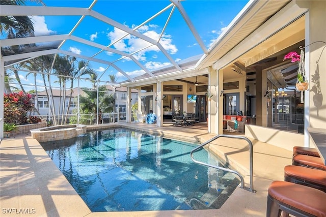 view of swimming pool featuring glass enclosure, a patio, and a pool with connected hot tub