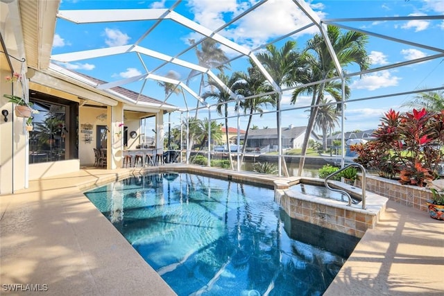 view of pool with a lanai, a water view, a pool with connected hot tub, and a patio