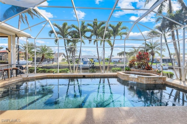 view of pool featuring a lanai, a pool with connected hot tub, and a patio