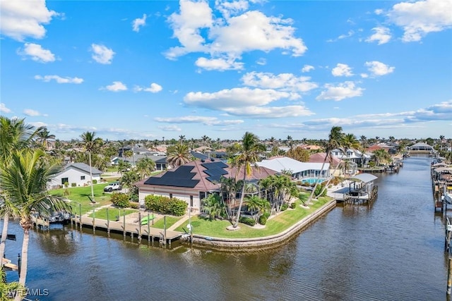 birds eye view of property featuring a water view and a residential view