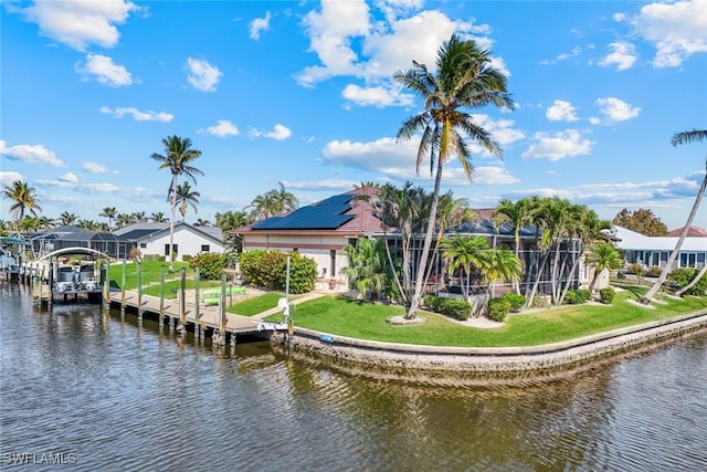 view of dock with a lawn, a water view, and a residential view