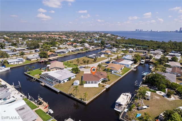 birds eye view of property featuring a water view and a residential view