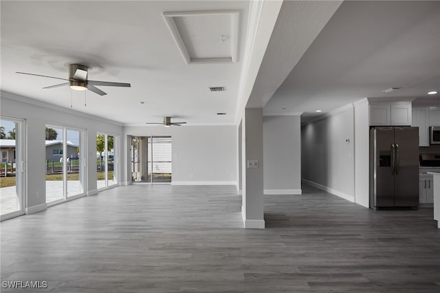 unfurnished living room with dark wood-style floors, baseboards, visible vents, and ornamental molding