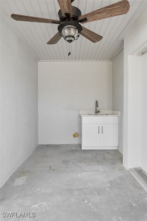 interior space featuring ceiling fan and a sink