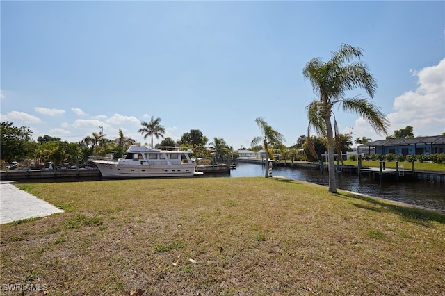 view of yard with a dock and a water view