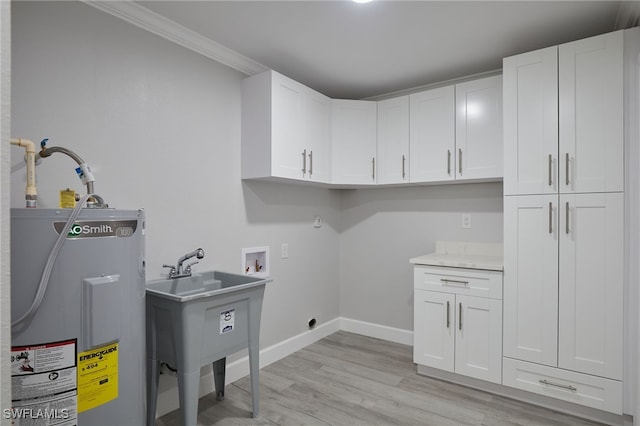 washroom with cabinet space, baseboards, light wood-style flooring, electric water heater, and hookup for a washing machine