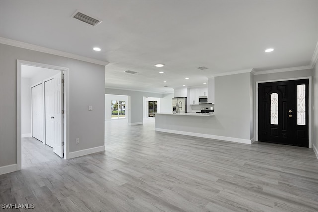 unfurnished living room with ornamental molding, visible vents, and baseboards