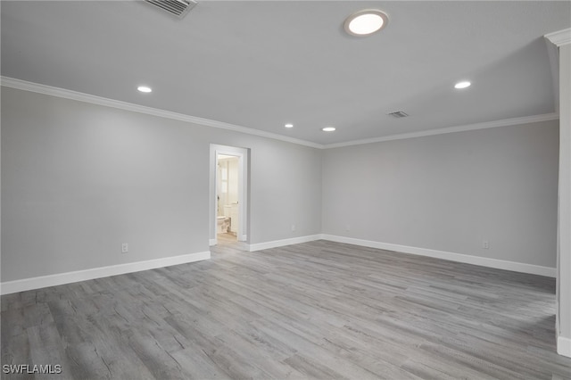 spare room with baseboards, visible vents, wood finished floors, crown molding, and recessed lighting