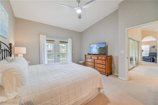 bedroom with baseboards, arched walkways, light colored carpet, access to exterior, and french doors