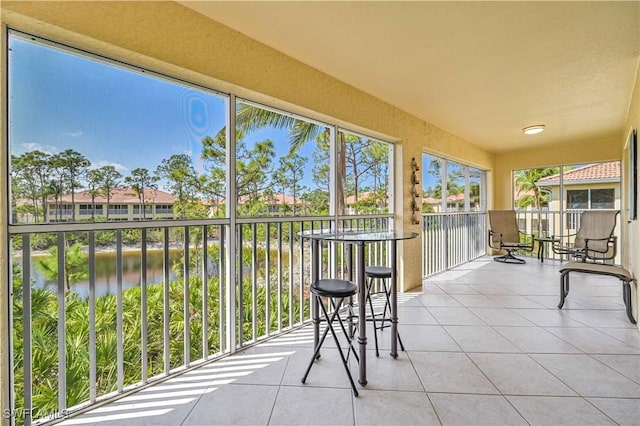 unfurnished sunroom with a water view