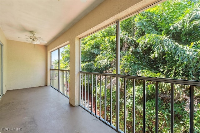 unfurnished sunroom with a ceiling fan