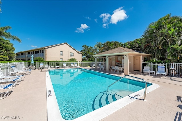 pool with fence and a patio