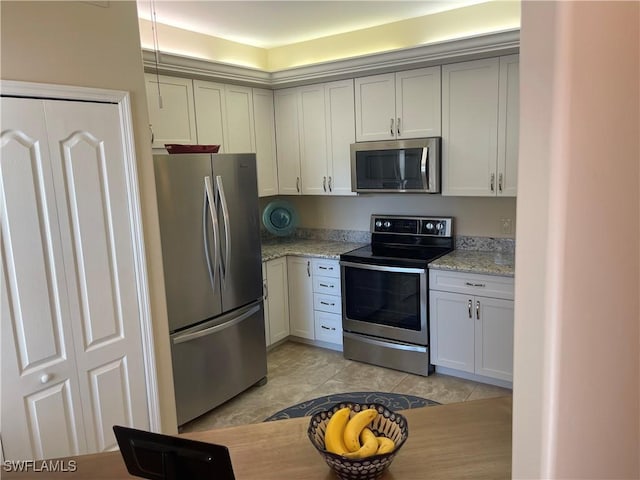 kitchen with appliances with stainless steel finishes and light stone countertops