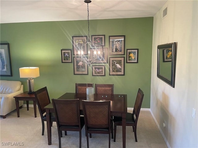 dining room with carpet floors, visible vents, a chandelier, and baseboards