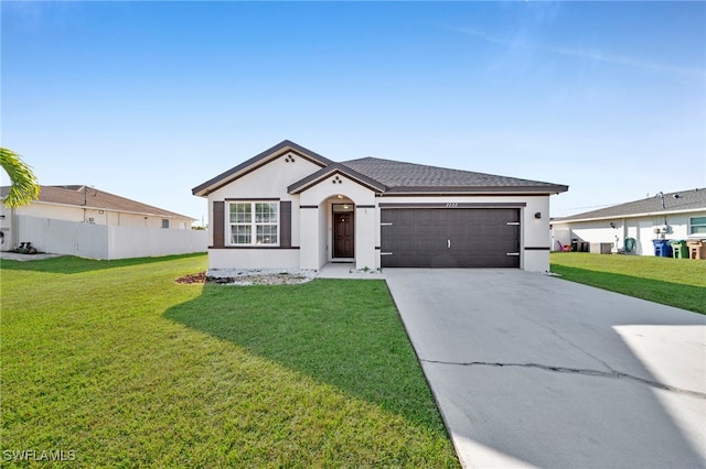 ranch-style home featuring stucco siding, fence, a garage, driveway, and a front lawn